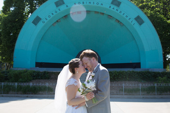 couple touching foreheads in front of stage