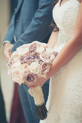 bride holding bouquet during church ceremony