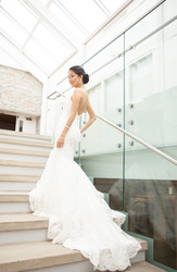 stylish pose of Asian bride on glass staircase
