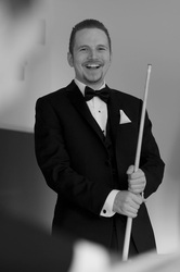 groom in tuxedo with pool cue