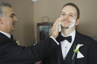 groom getting a shave on wedding day