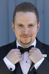 groom adjusting bow tie