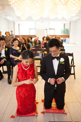 chinese bride and groom kneeling during wedding tea ceremony