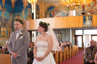 bride and groom exchanging wedding vows in ukranian orthodox church
