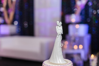 wedding cake with couple embracing figurines