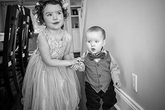 flower girl in a lavender dress and and her baby brother wearing a suit 