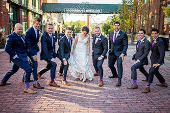 bridal party posing in a funny way in the distillery district Toronto