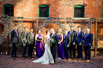bride and groom kissing in a traditional pose with bridal party
