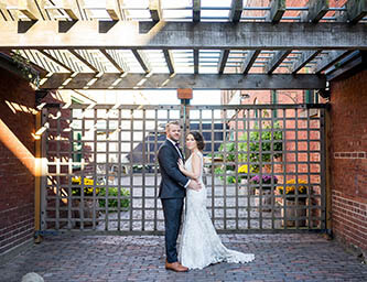 traditional pose of bride and groom in distillery in Toronto
