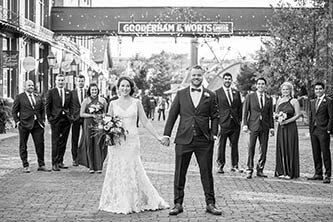 bride and groom in front of the bridal party in distillery district in Toronto