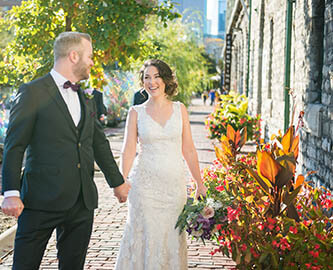 sunset photo of the couple walking in distillery district in Toronto