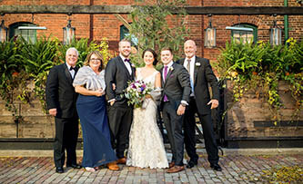 traditional pose of bride and groom with immediate family 