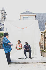 bride and groom sitting in front of the officiant wedding ceremony