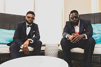 groom and best men taking photos in the hotel lobby