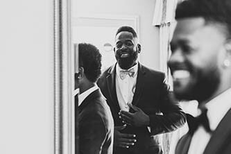 black and white photo of the groom smiling with his groomsmen