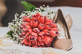 pink and white wedding bouquet and beige wedding shoes