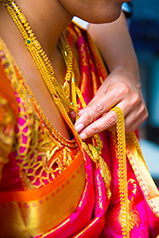close up of indian bride's gold jewelry and gold necklace