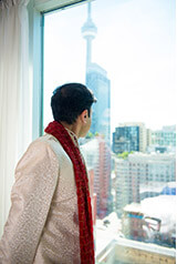 groom looking at the cn tower from four seasons hotel toronto